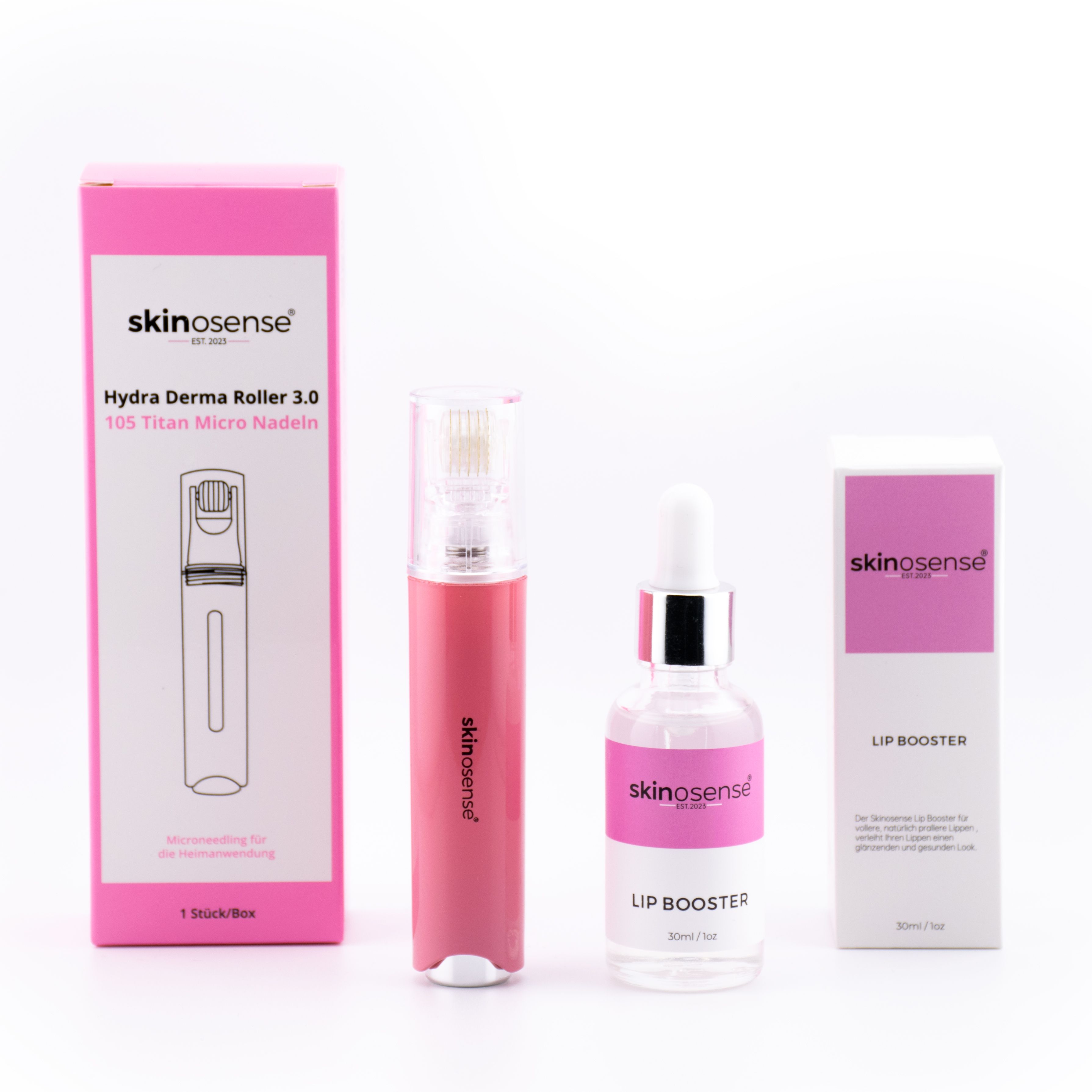 Set mit Hydra Derma Roller, Lip Booster Serum und zwei Verpackungen. Rosa und weiße Verpackung mit Produktnamen.