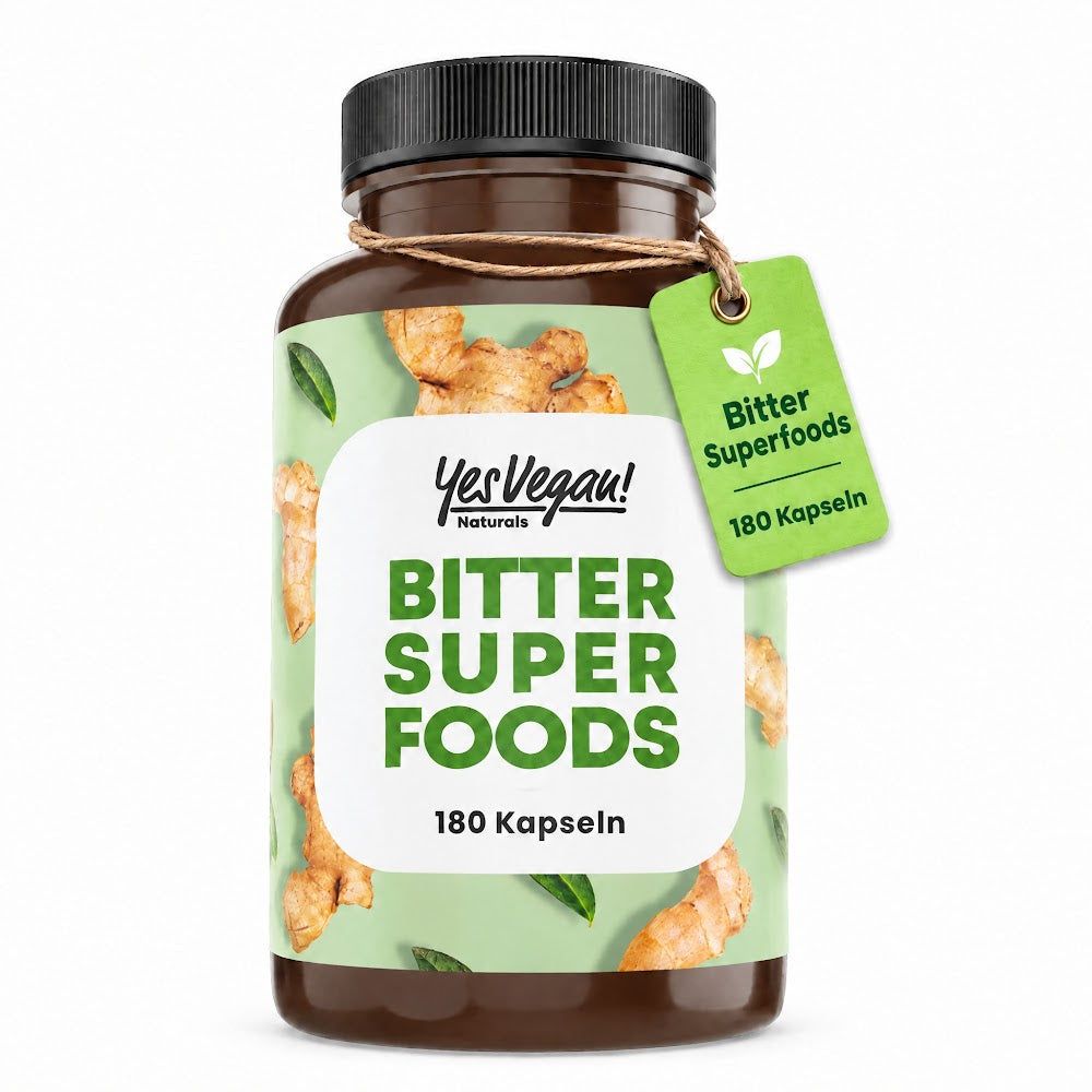 Braune Kapsel-Flasche mit Etikett: Yes Vegan! Naturals Bitter Super Foods, 180 Kapseln. Hintergrund mit Ingwer-Motiven.