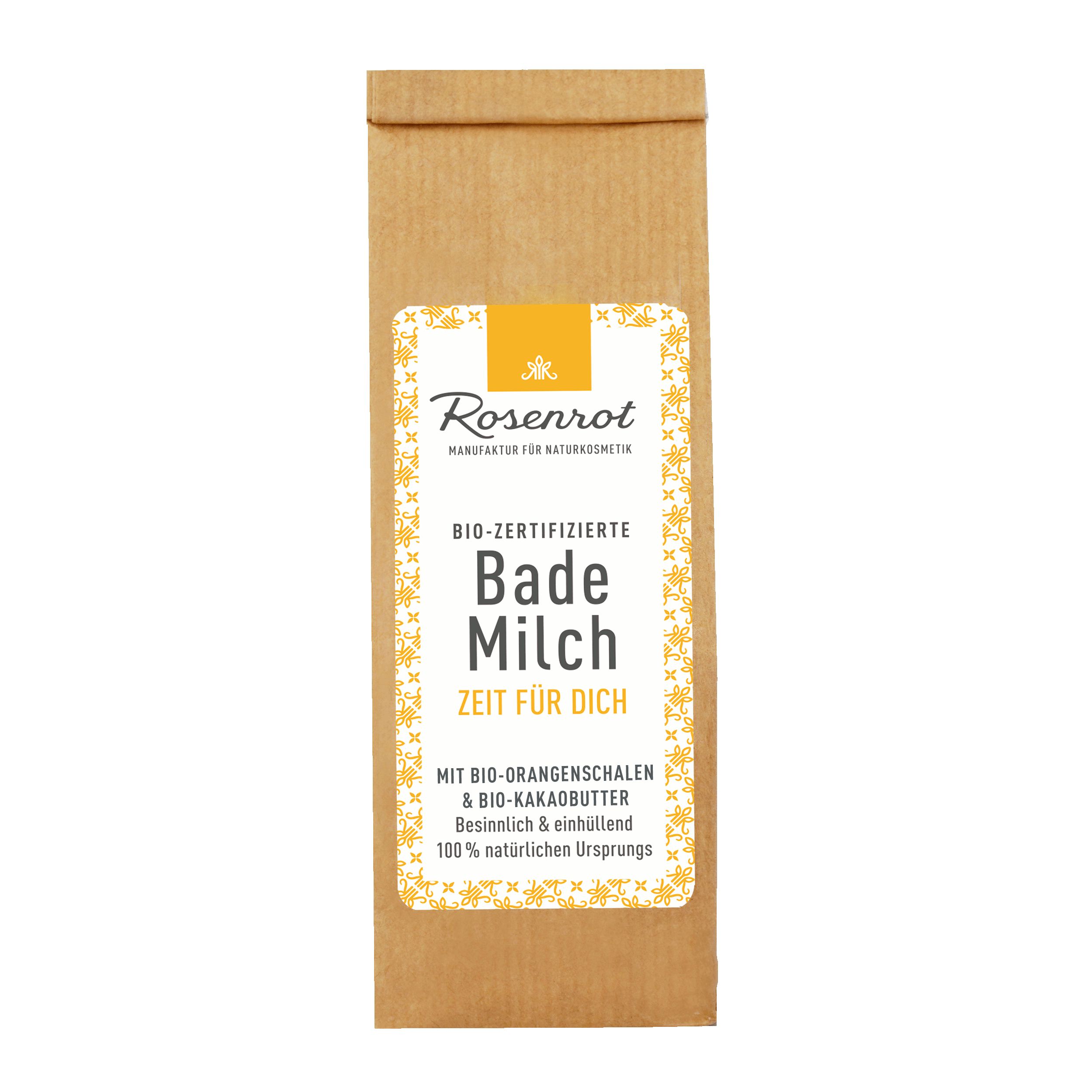Braune Papiertüte mit Etikett. Aufschrift: Bademilch, Zeit für Dich. Bio-zertifiziert. Mit Orangenschalen und Kakaobutter.