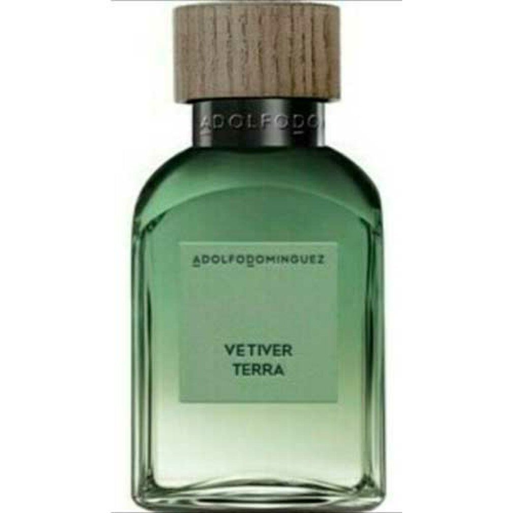 Grüne Glasflasche mit Holzverschluss. Aufschrift: ADOLFODOMINGUEZ, VETIVER TERRA. Quadratische Form mit abgerundeten Ecken.