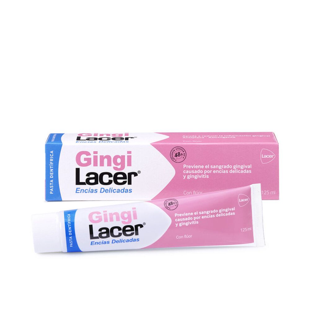 Zahnpasta-Tube und -Schachtel. Rosa und weiße Verpackung. Aufschrift: Gingi Lacer, Encias Delicadas. Enthält Fluorid.