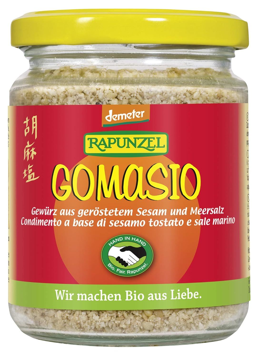Rapunzel Gomasio Gewürz aus geröstetem Sesam und Meersalz in einem Glasbehälter mit gelbem Deckel.