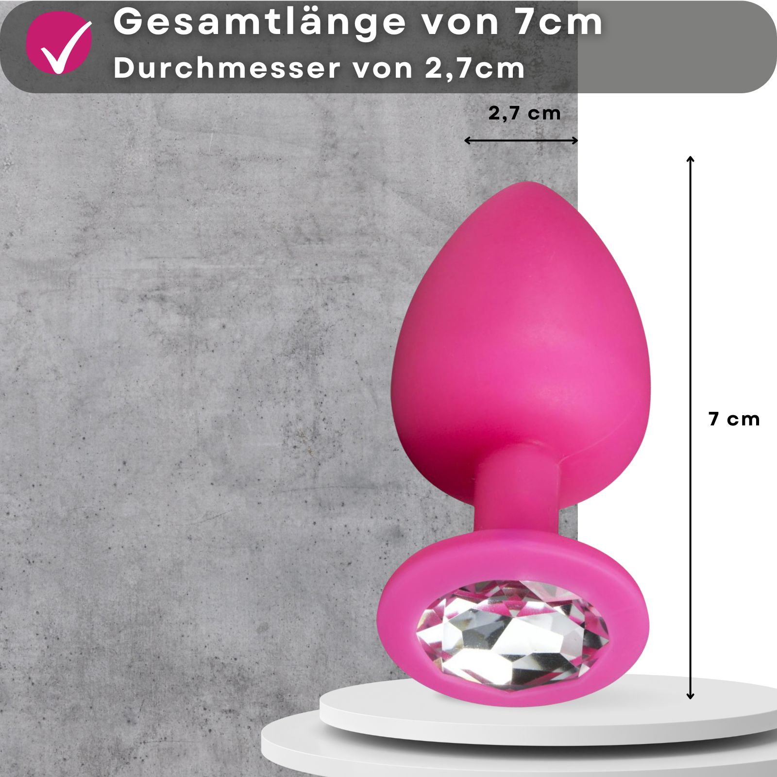 Pinkfarbener Analplug mit Zierstein. 7cm lang, 2,7cm Durchmesser. Maße angegeben.
