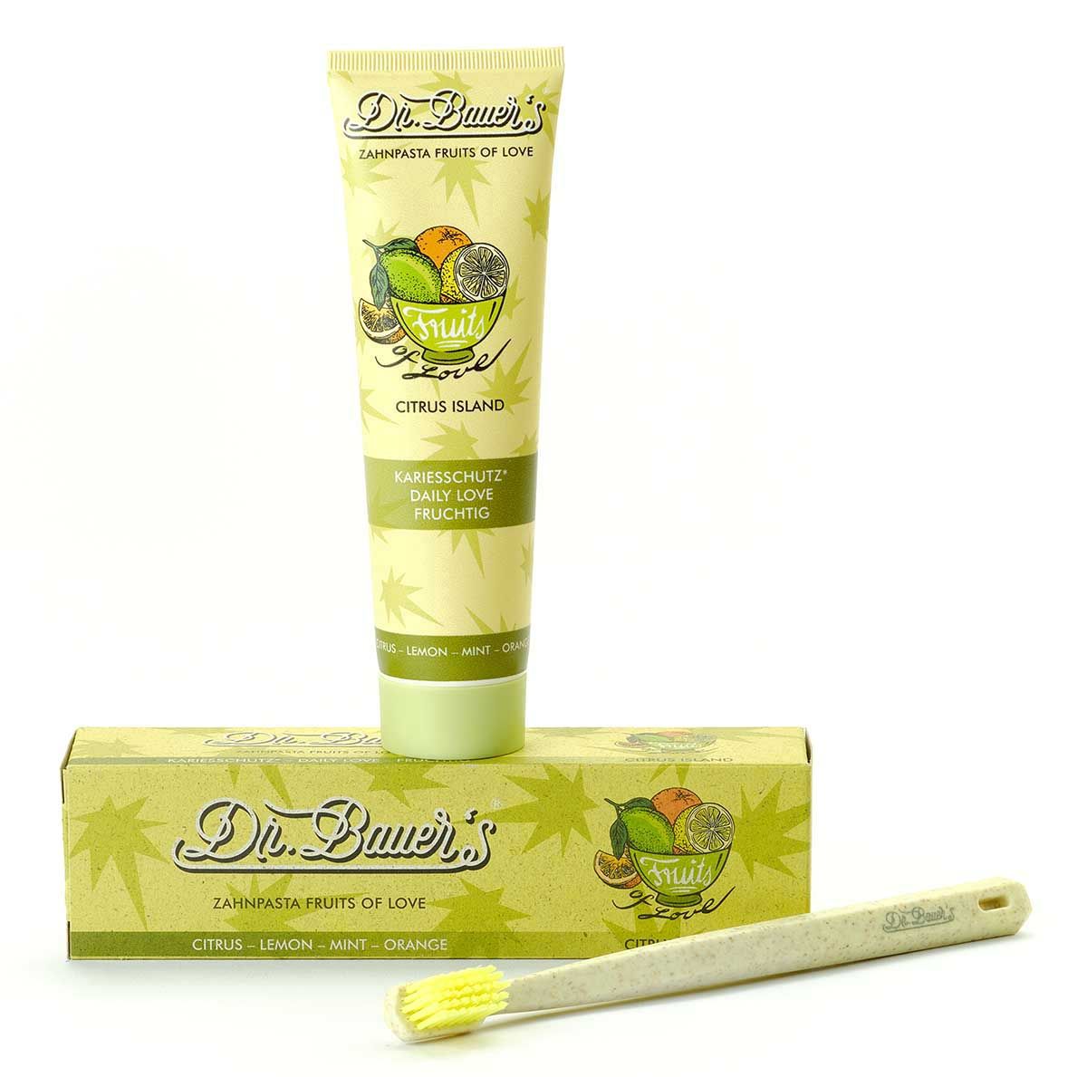 Zahnpasta-Tube, Schachtel und Zahnbürste. Tube und Schachtel mit Schriftzug und Frucht-Illustration. Zahnbürste beige.