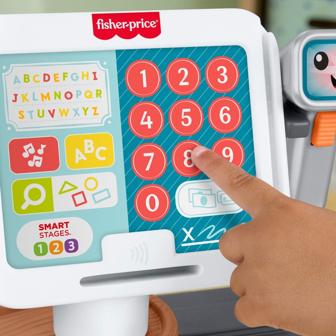 Nahaufnahme der Spielzeugkasse. Tastenfeld mit Zahlen und Buchstaben. Fisher-Price Logo.
