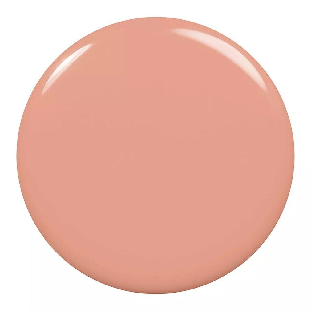 Runder, glänzender Nagellack-Fleck in einem helleren Beige-Ton. Glatte Oberfläche.