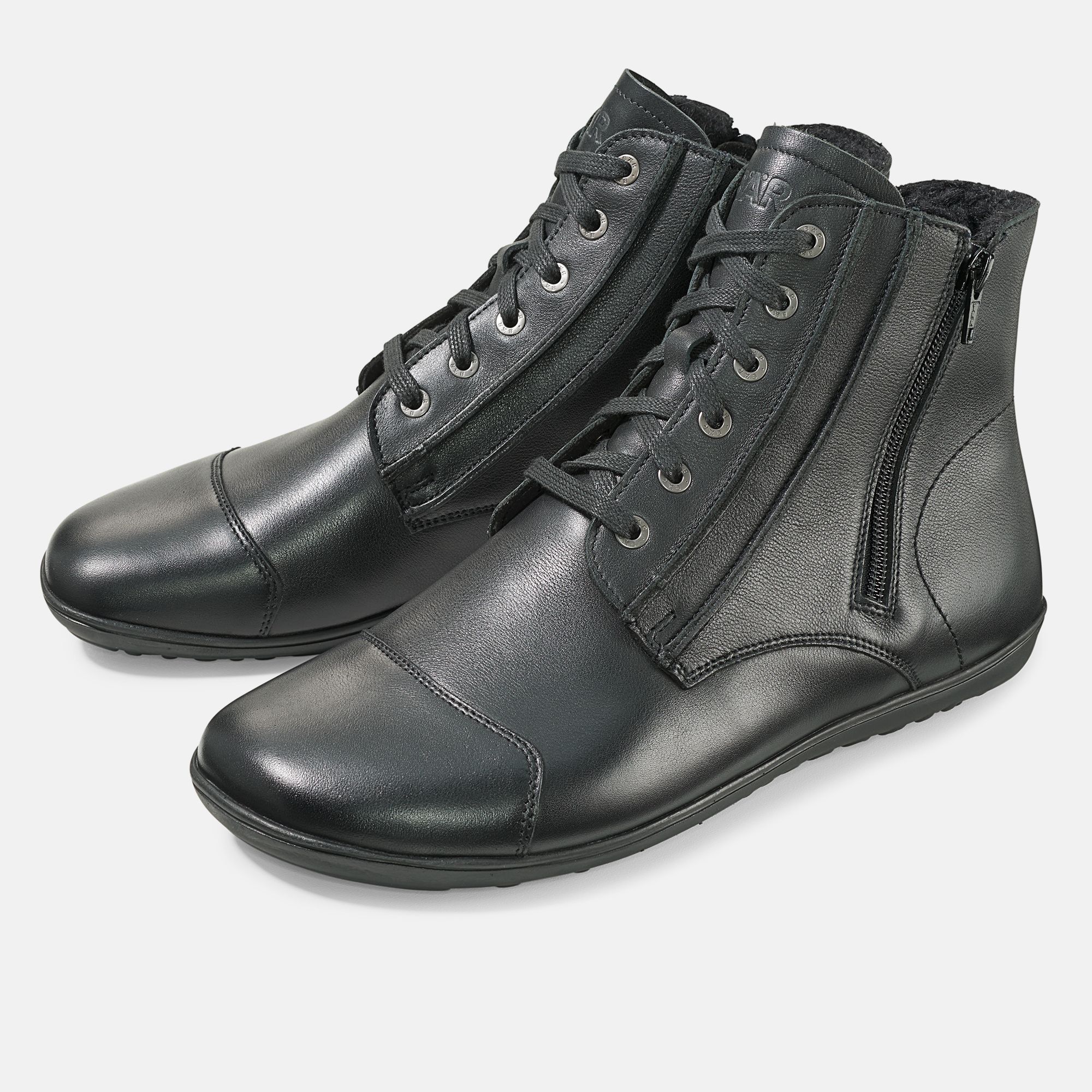 Schwarze Stiefeletten mit Schnürung und Reißverschluss. Breite Passform. Leder. Zwei Schuhe nebeneinander.