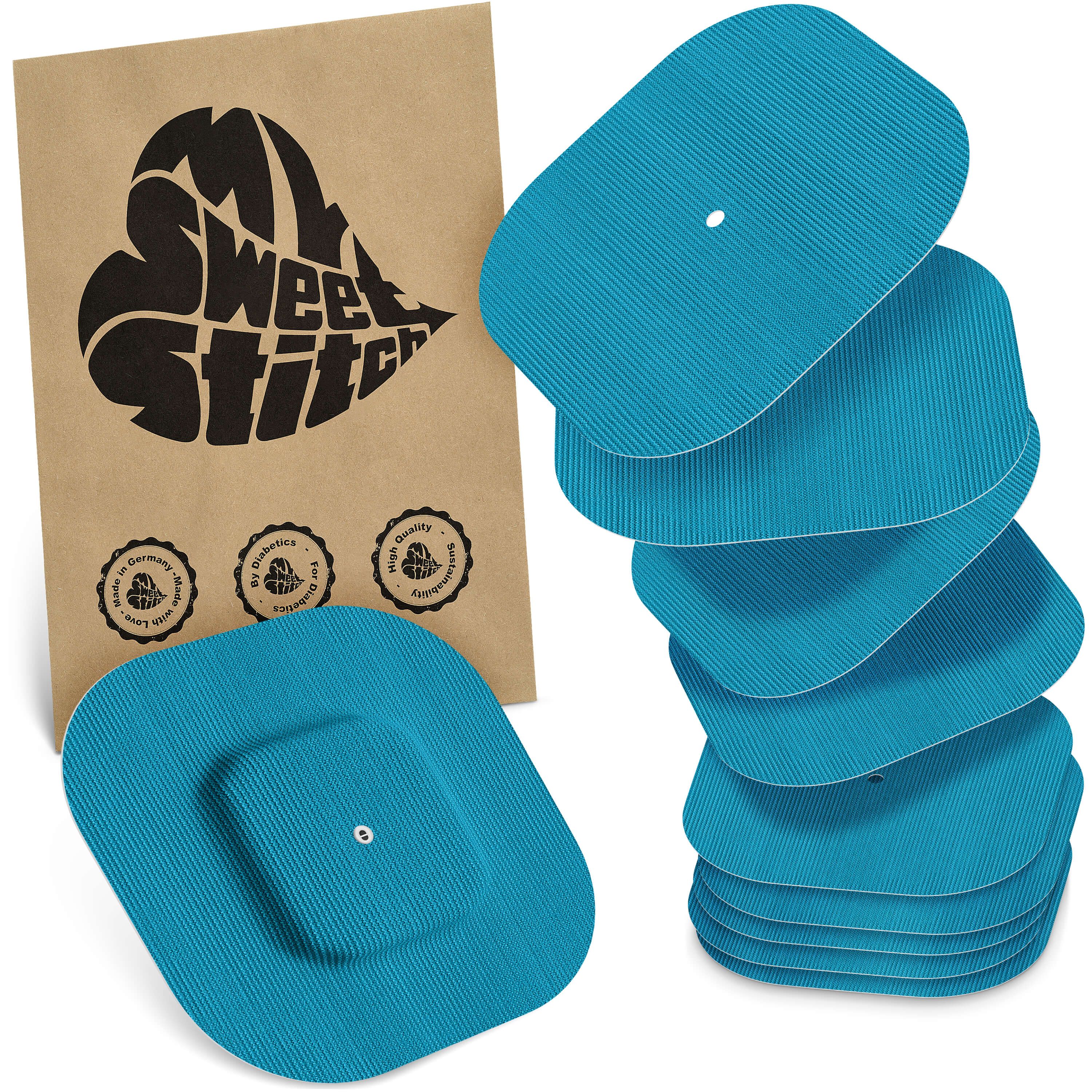 Blaue, rechteckige Pflaster mit quadratischer Mitte. Auf brauner Verpackung steht "MySweetStitch". Siegel: Made in Germany, Qualität.