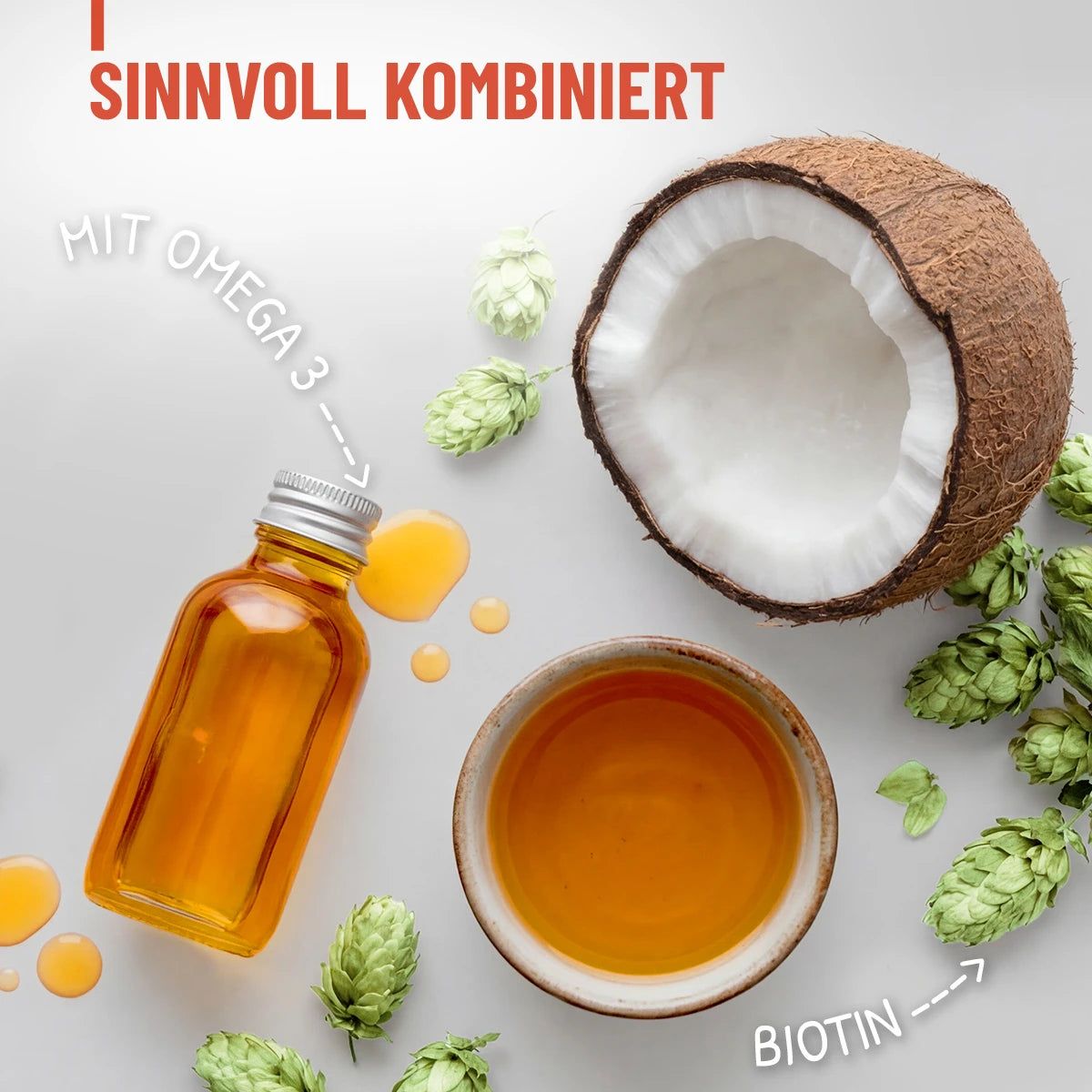Kombination aus Kokosnuss, Öl und Hopfen. Text: Mit Omega 3 und Biotin. Öl in einer kleinen Flasche mit silbernem Deckel. Kokosnuss in Scheiben.