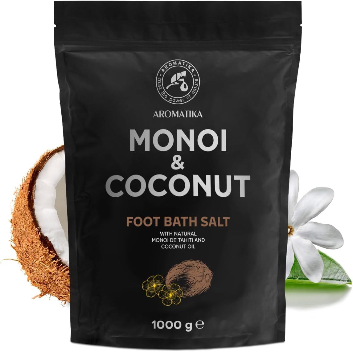Schwarze Verpackung mit Produktnamen und Logo. Kokosnuss und Blüte als Dekoration. Text: Monoi & Coconut Foot Bath Salt.