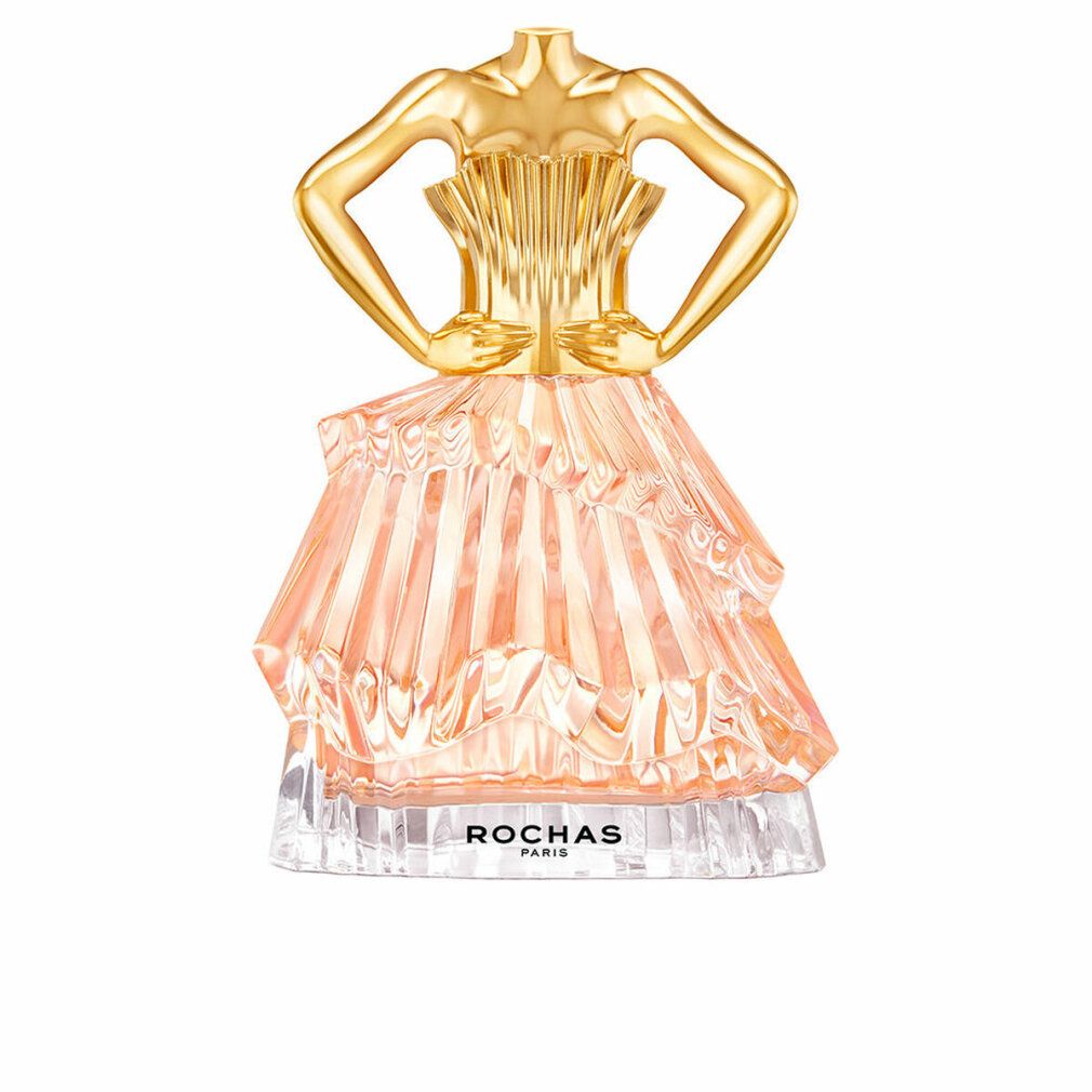 Parfümflakon in Form eines Kleides. Goldfarbener Oberteil, rosa Rock. Aufschrift: ROCHAS PARIS.