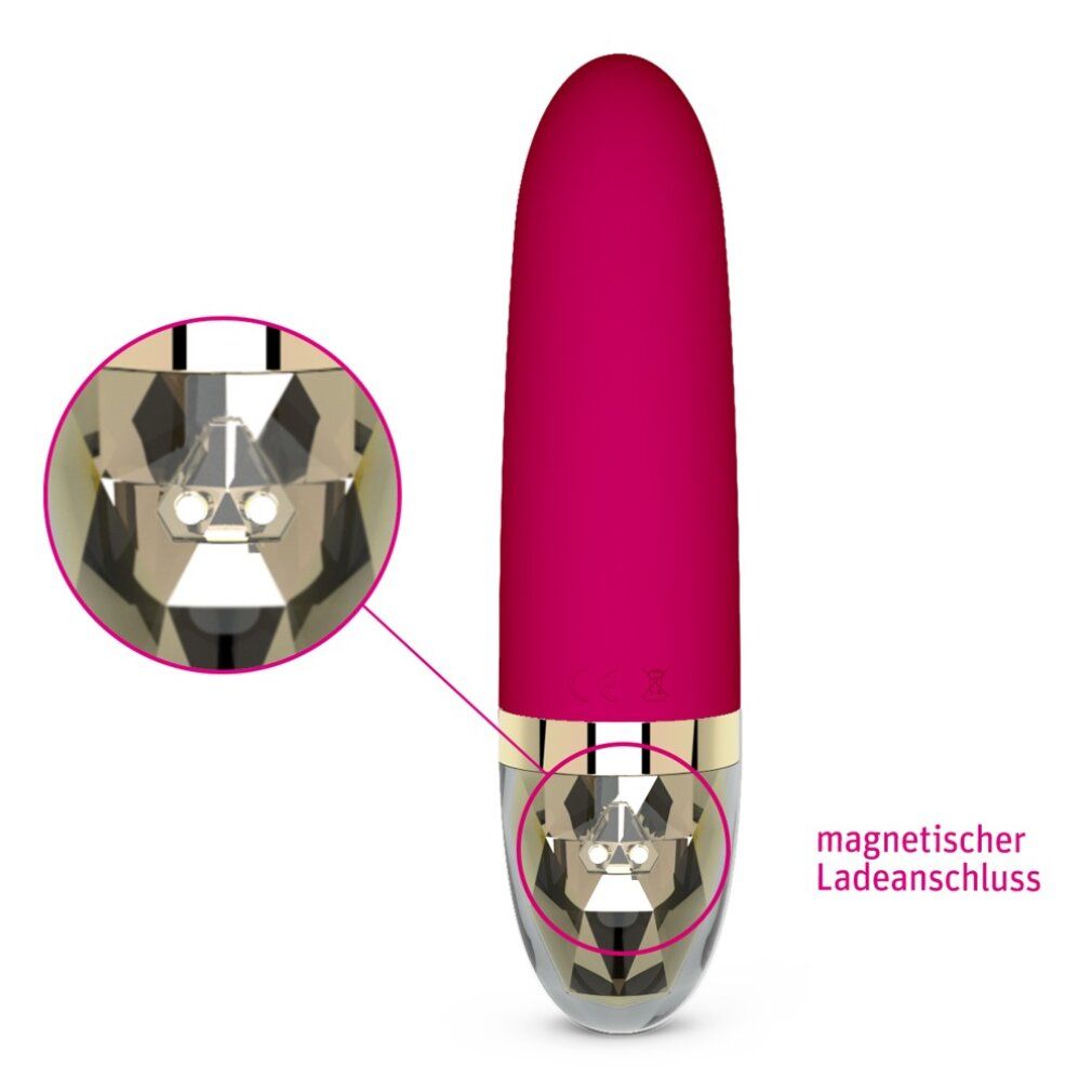 Fuchsiafarbener Vibrator mit goldfarbenen Akzenten. Nahaufnahme der magnetischen Ladeanschluss-Details.