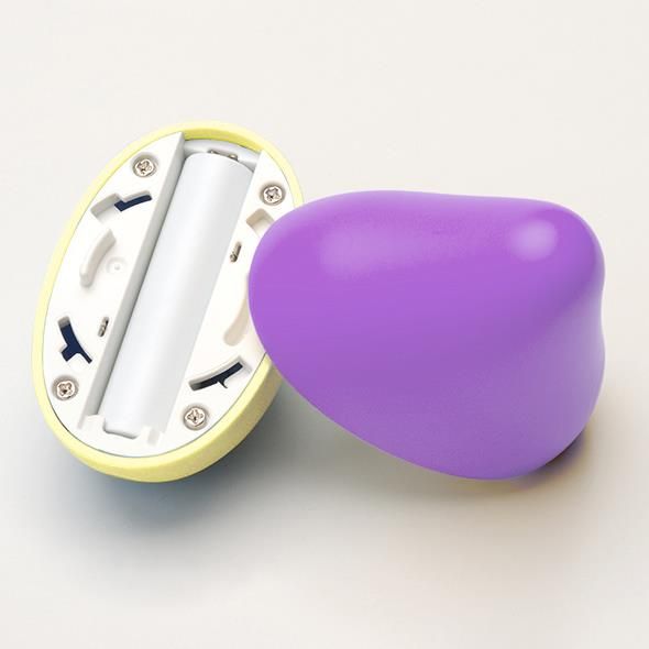 Produkt in zwei Teilen. Oberteil lila, Unterteil gelb. Unterteil mit Batteriefach und Schrauben. Batterie eingesetzt.