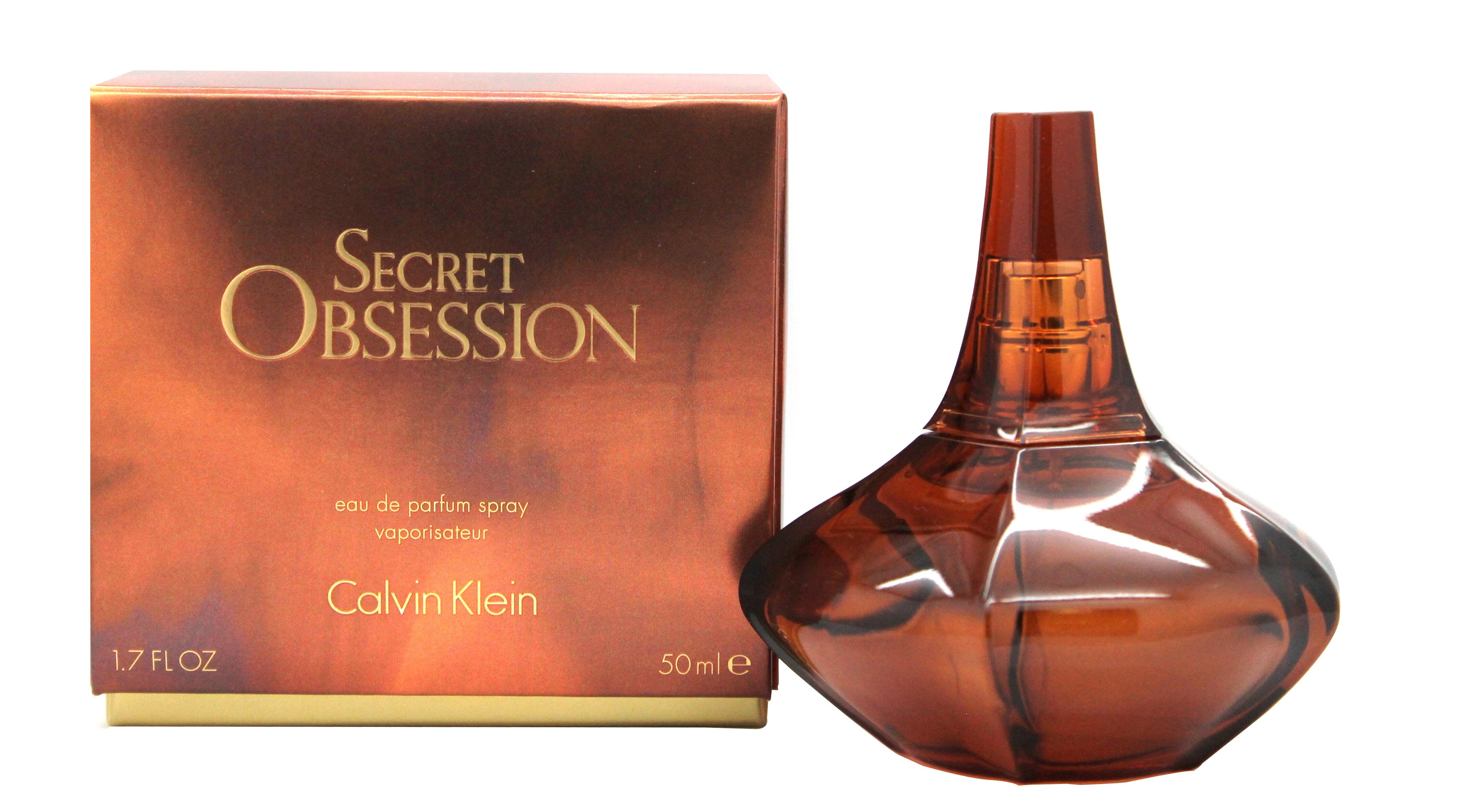 Parfümflakon und Verpackung. Flakon aus braunem Glas, birnenförmig. Verpackung mit Schriftzug Secret Obsession und Calvin Klein.