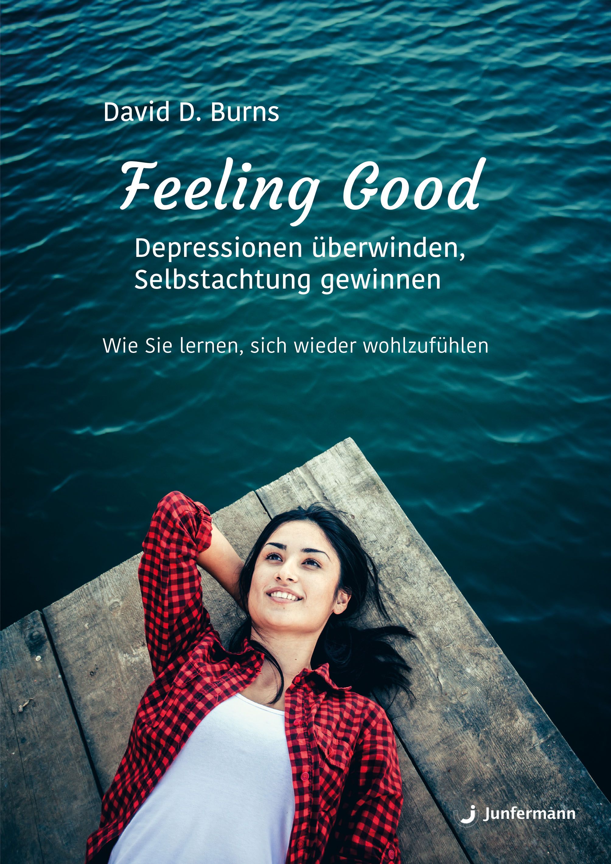 Buchcover: Feeling Good. Titel und Untertitel in weißer Schrift. Autor: David D. Burns. Junfermann-Logo unten rechts. Frau auf Steg.