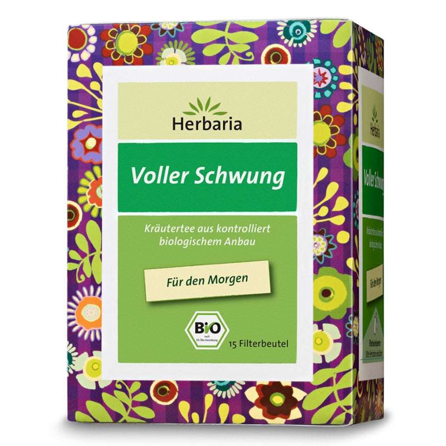 Kräutertee-Verpackung mit floralem Muster. Text: Herbaria, Voller Schwung, Bio. 15 Filterbeutel. Zertifizierung: Bio-Siegel.