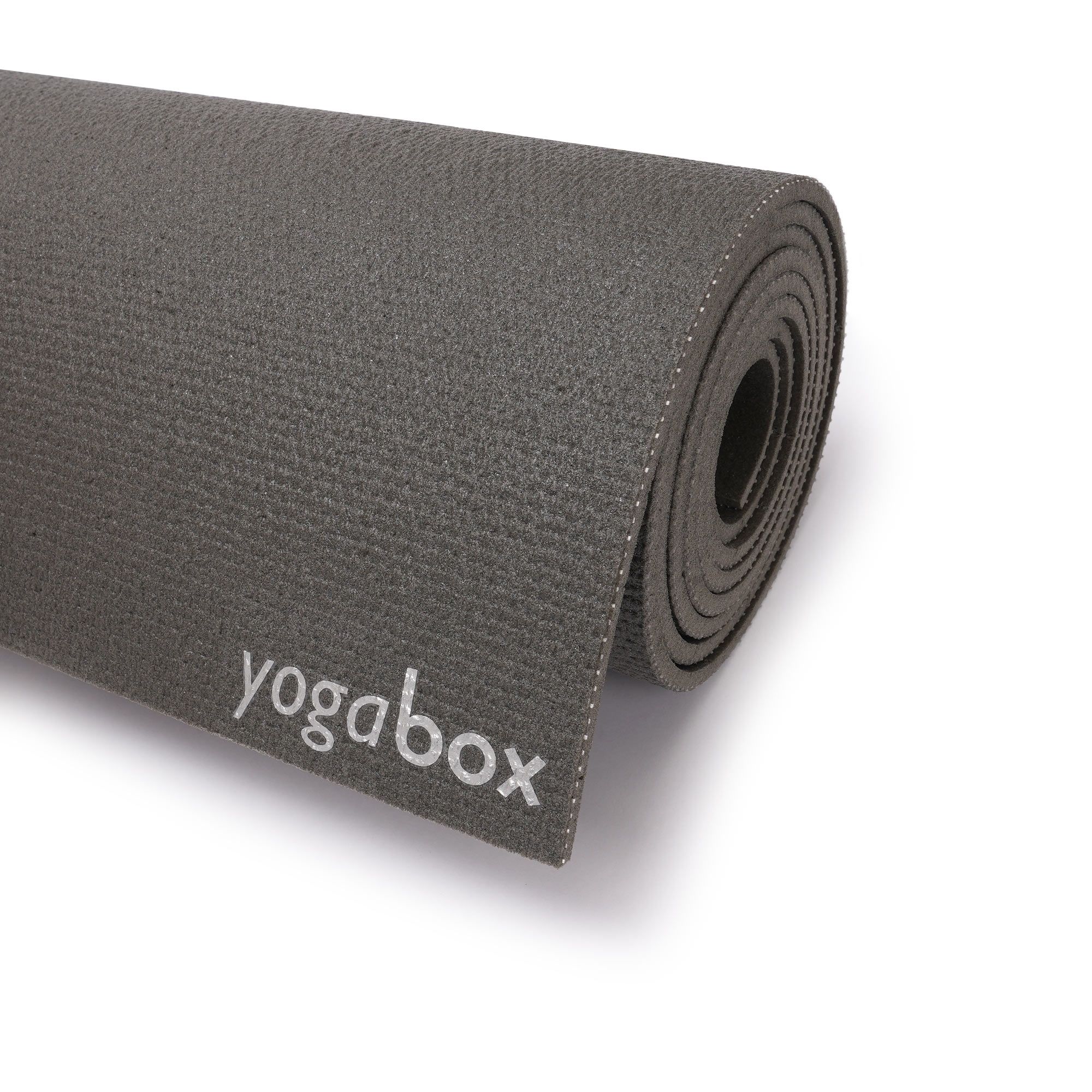 Gerollte Yogamatte mit sichtbarem 'yogabox'-Logo auf der Seite.