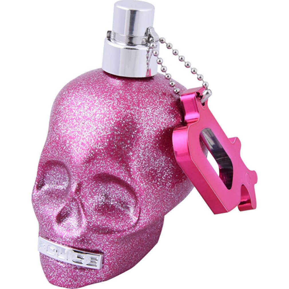 Glitzernde pinke Totenkopf-Parfümflasche mit silbernem Sprühkopf und Anhänger.
