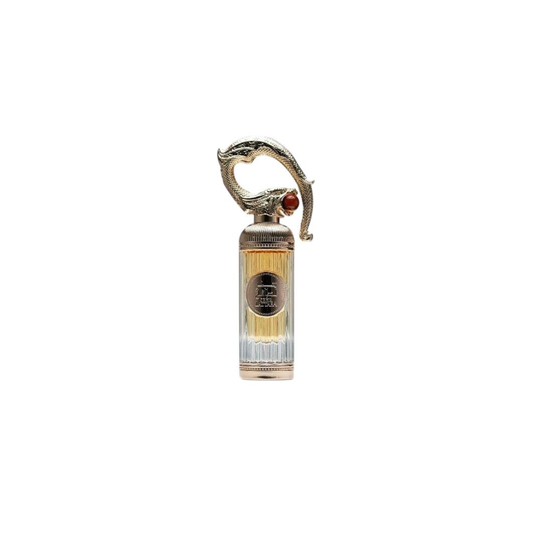 Parfümflakon mit goldfarbenem Verschluss und rotem Schmuckstein. Der Flakon ist länglich und hat eine transparente Basis.