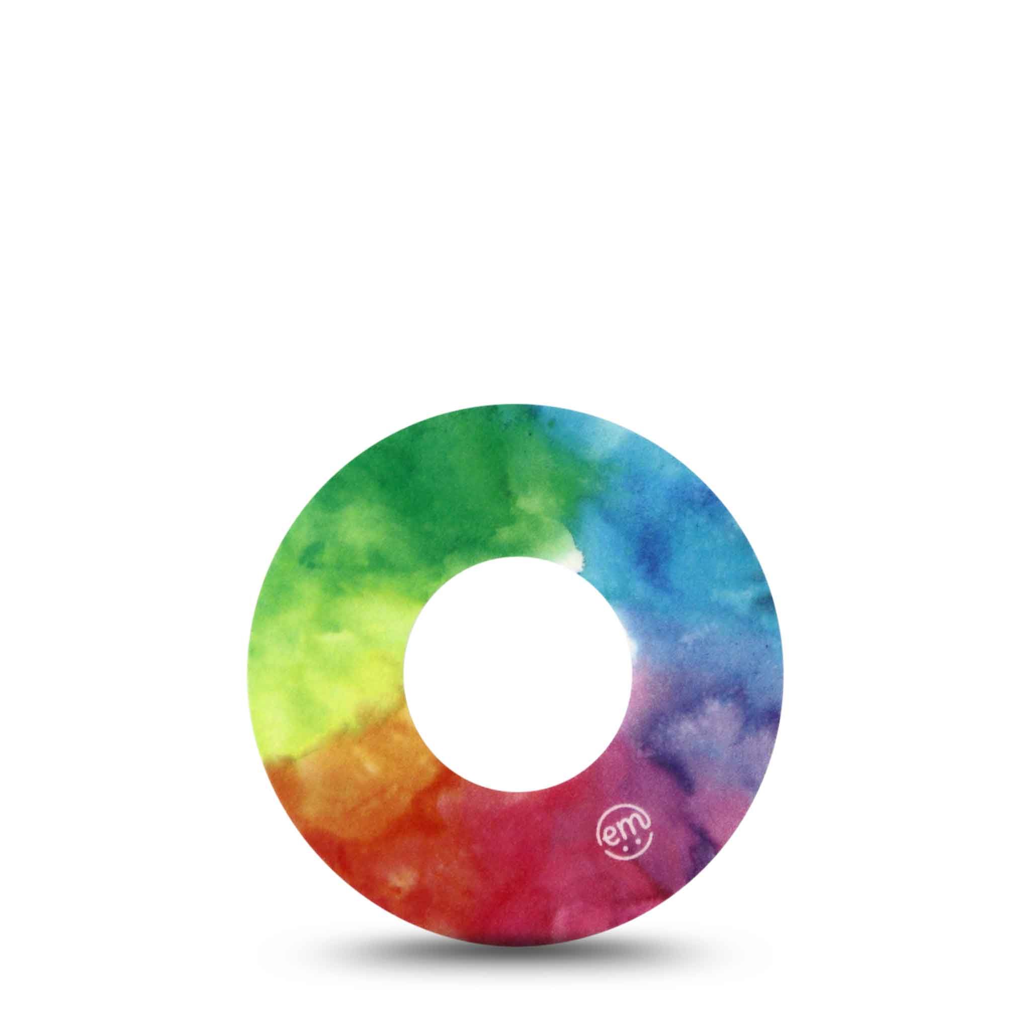 Runder Fixierring mit Regenbogen-Aquarelldesign. Weißes Loch in der Mitte. Kleines Logo sichtbar.