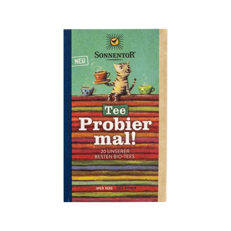 Verpackung mit Aufdruck von Katze, Tassen und Schriftzug "Tee Probier mal!". Marke Sonnentor. Mit 20 Bio-Tees.