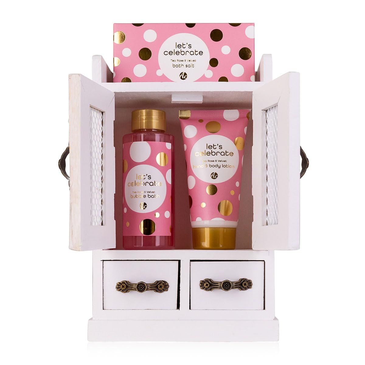 Geschenkset in weißem Schrank. Enthält rosa Produkte mit weißen und goldenen Punkten. Sichtbar: Duschgel, Bodylotion, Badesalz.