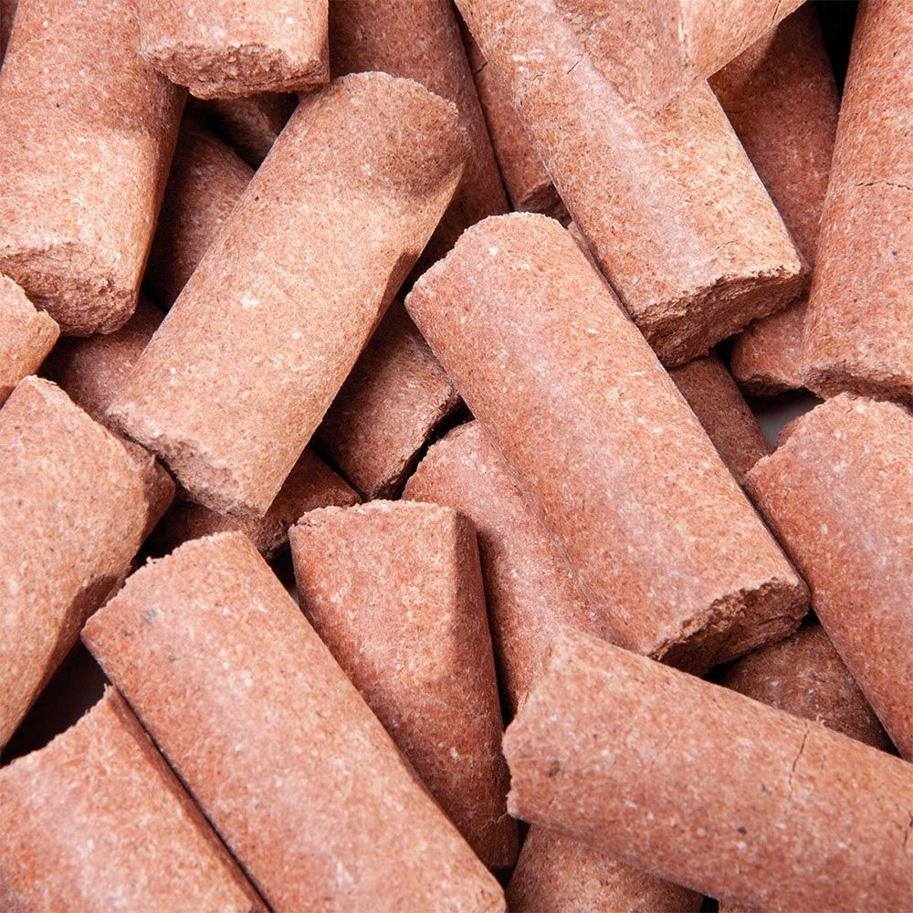 Haufen von zylindrischen, roten Lecker Bricks. Rauhe Oberfläche, abgebrochene Enden. Nahaufnahme.