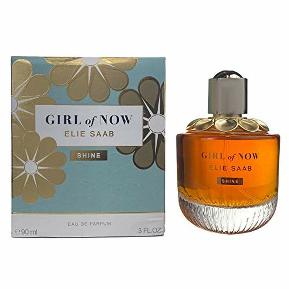 Parfümflasche und Schachtel. Aufschrift: GIRL of NOW, ELIE SAAB, SHINE. Schachtel mit Blumenmuster. Flasche mit goldfarbenem Deckel.