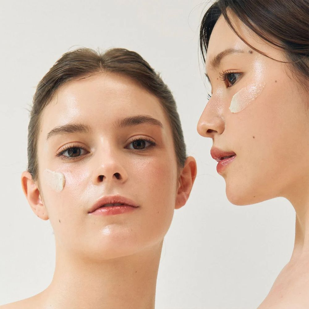 Zwei Frauen mit BEAUTY OF JOSEON Ground Rice and Honey Glow Mask auf den Wangen.