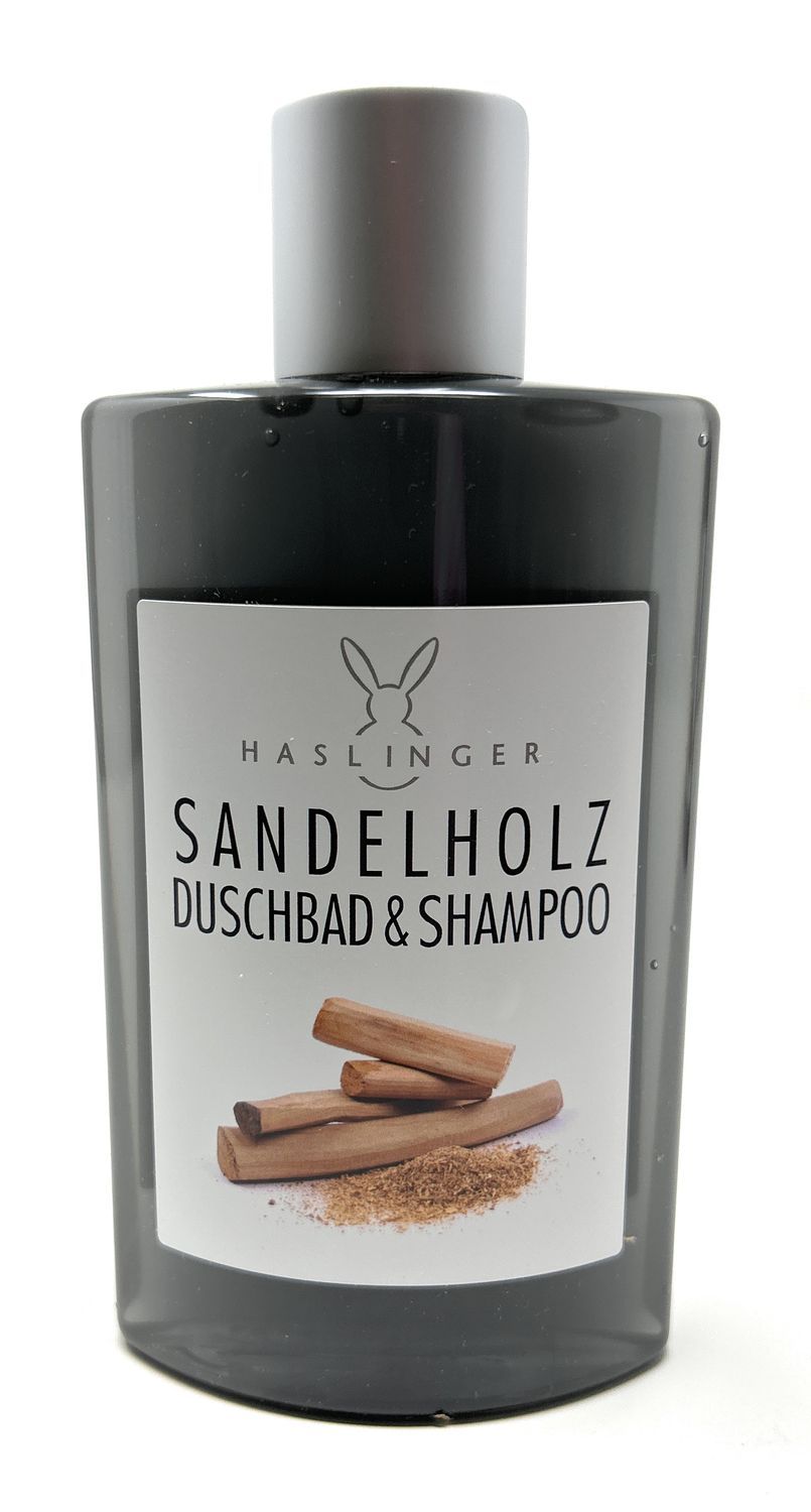 Duschbad & Shampoo Flasche. Schwarze Flasche mit silbernem Deckel. Etikett mit Sandelholz-Illustration und Schriftzug.