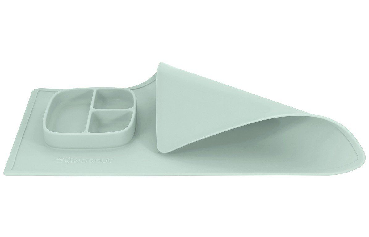 Aquamarinfarbene Spielmatte mit integriertem, dreigeteiltem Teller. Teilweise aufgerollt, zeigt die Unterseite.