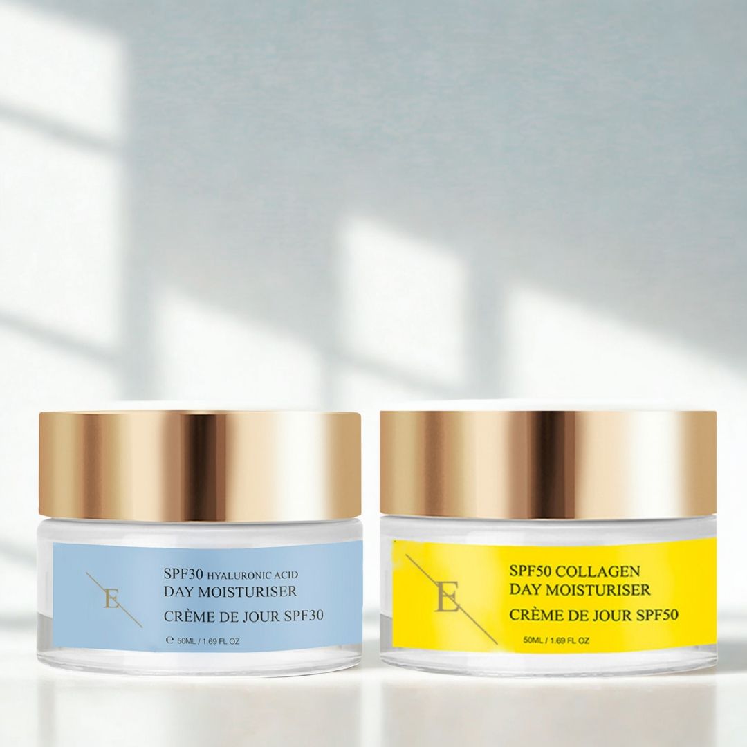 Zwei Cremes mit goldenen Deckeln und Etiketten. Auf den Etiketten steht "SPF30" und "SPF50". Die Cremes stehen nebeneinander.