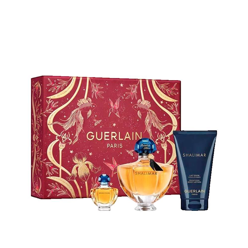 Geschenkset mit Flakons, Tube und Box. Flakons: rund, bernsteinfarben, blaue Deckel. Tube: dunkelblau. Box: rot, goldene Verzierungen. Aufschrift: GUERLAIN.