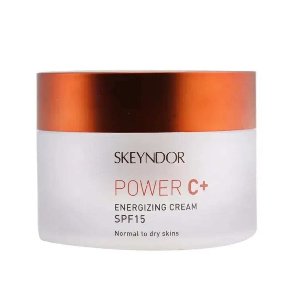 Weißer Tiegel mit orangefarbenem Deckel. Aufschrift SKEYNDOR, POWER C+, Energizing Cream SPF15.