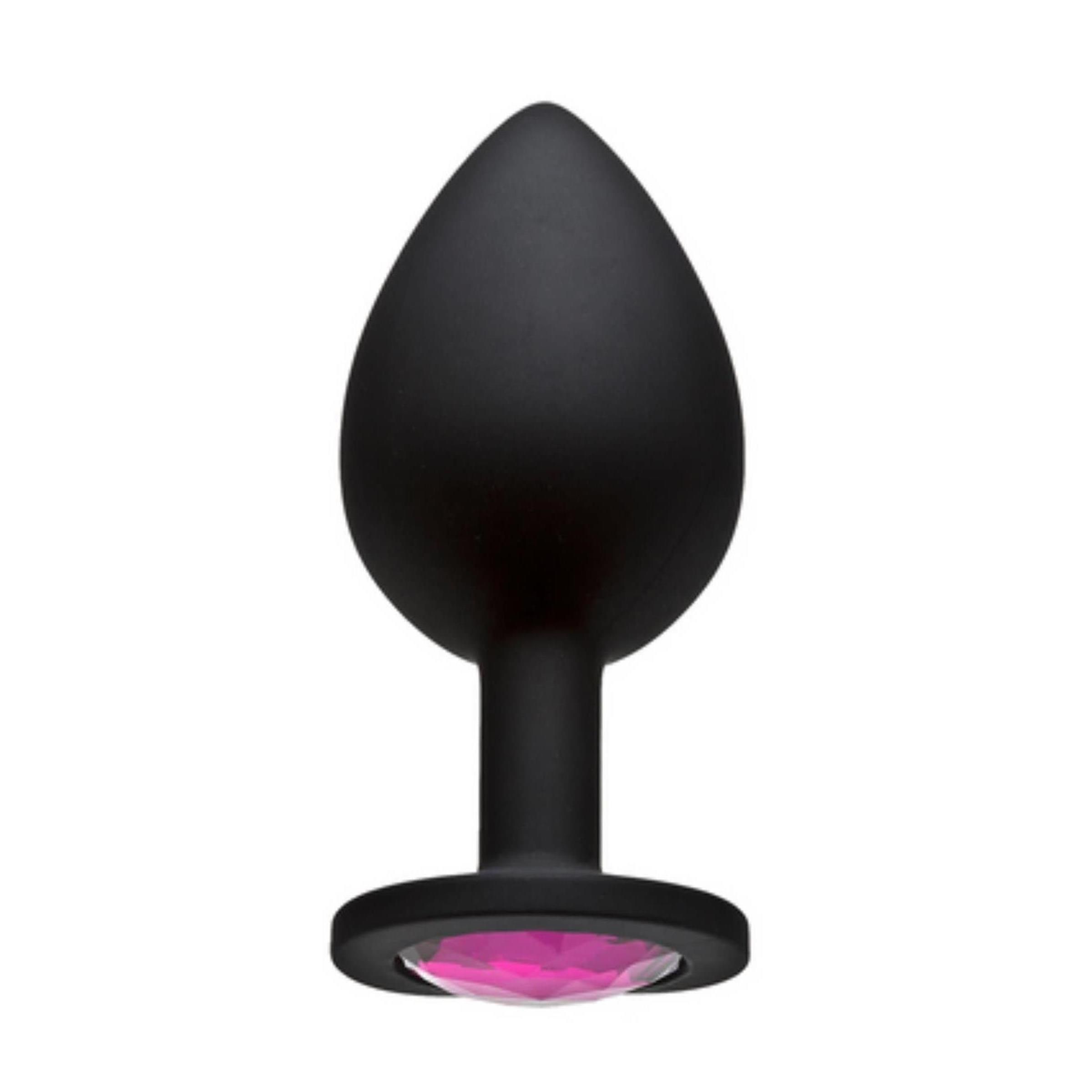 Schwarzer Plug mit pinkfarbenem Juwel. Tropfenförmiger Kopf, runder Sockel. Aus Silikon.