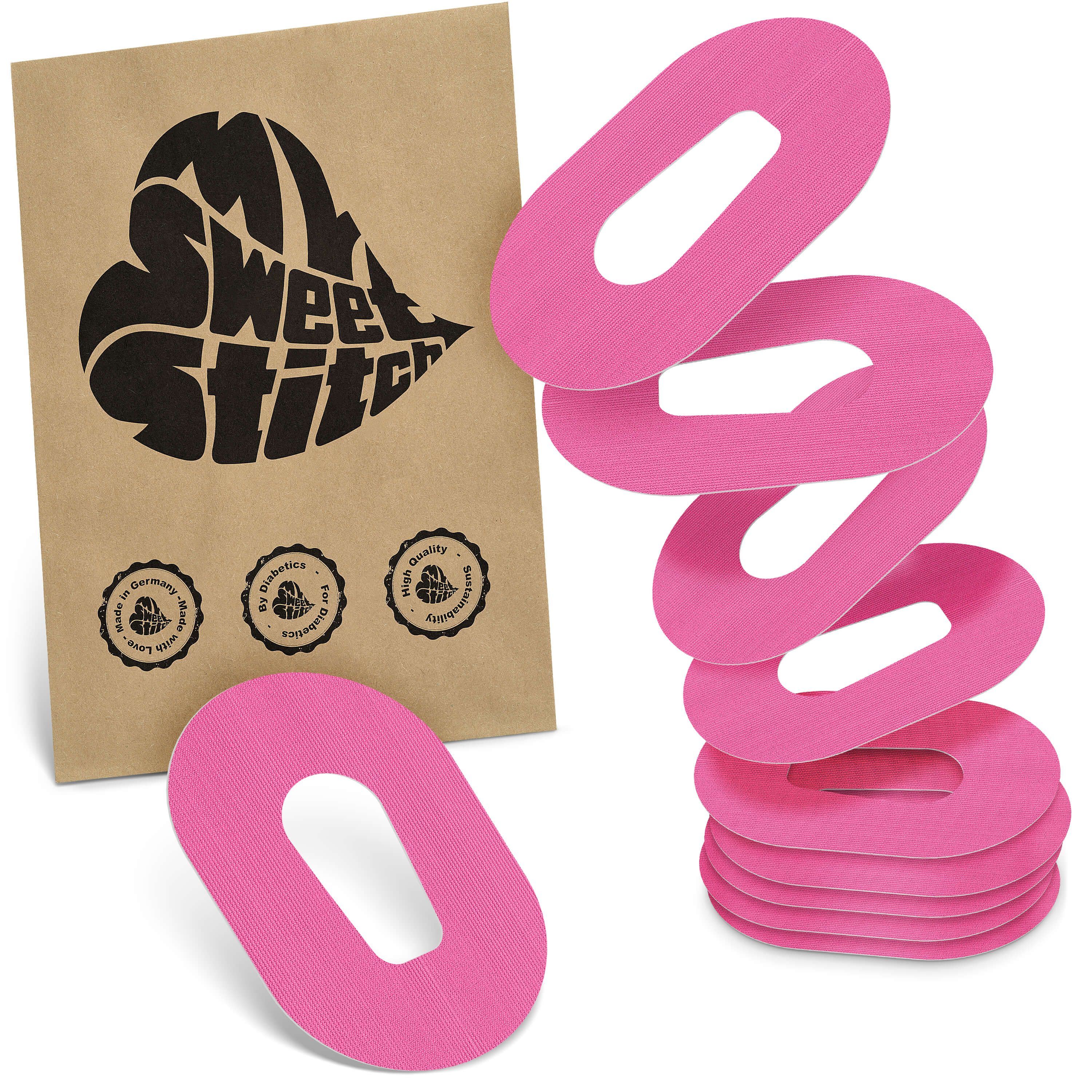 Rosa Fixierpflaster mit ovaler Form und Aussparung. Braune Verpackung mit Logo und Siegeln.