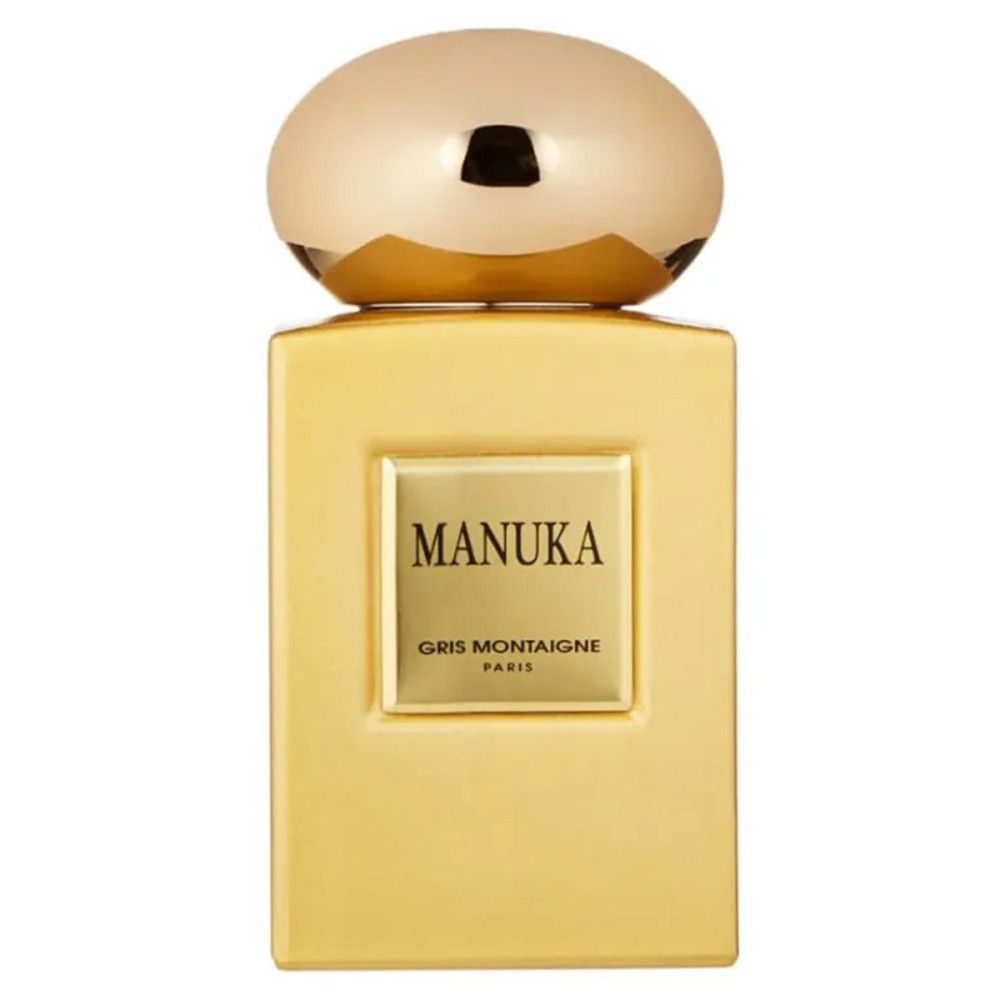 Flakon mit goldfarbenem Verschluss. Aufschrift MANUKA und GRIS MONTAIGNE PARIS auf quadratischem Etikett.