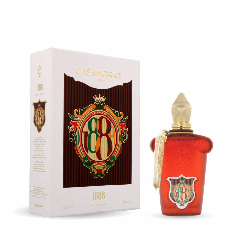 Rote Flasche mit goldener Kappe und Quaste, neben weißer Schachtel mit Logo und Schrift.