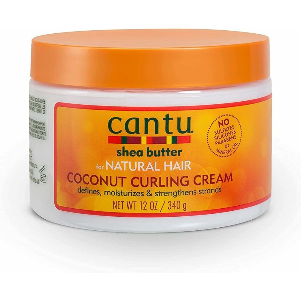Weißer Tiegel mit Cantu Shea Butter Coconut Curling Cream. Text: Für natürliches Haar, definiert, spendet Feuchtigkeit und stärkt Strähnen.
