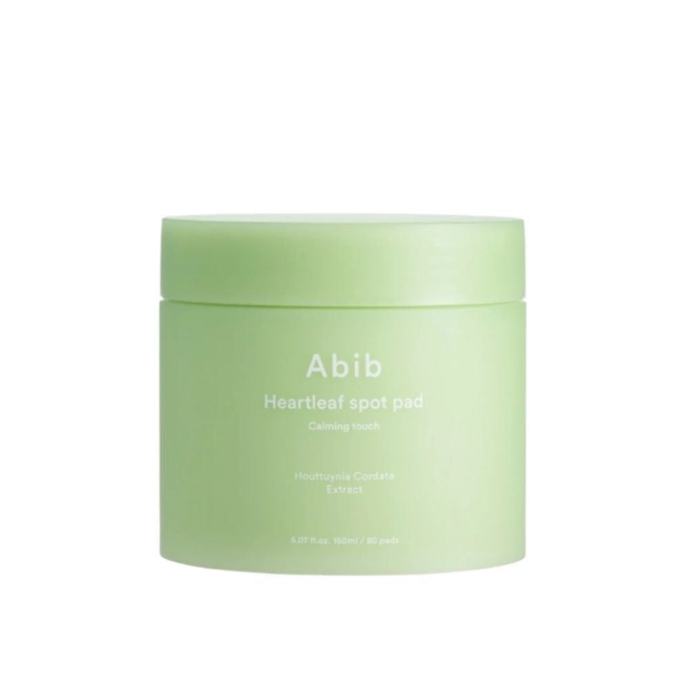Grüner Behälter mit Deckel. Aufschrift: Abib Heartleaf spot pad. Text darunter: Calming touch, Houttuynia Cordata Extract.