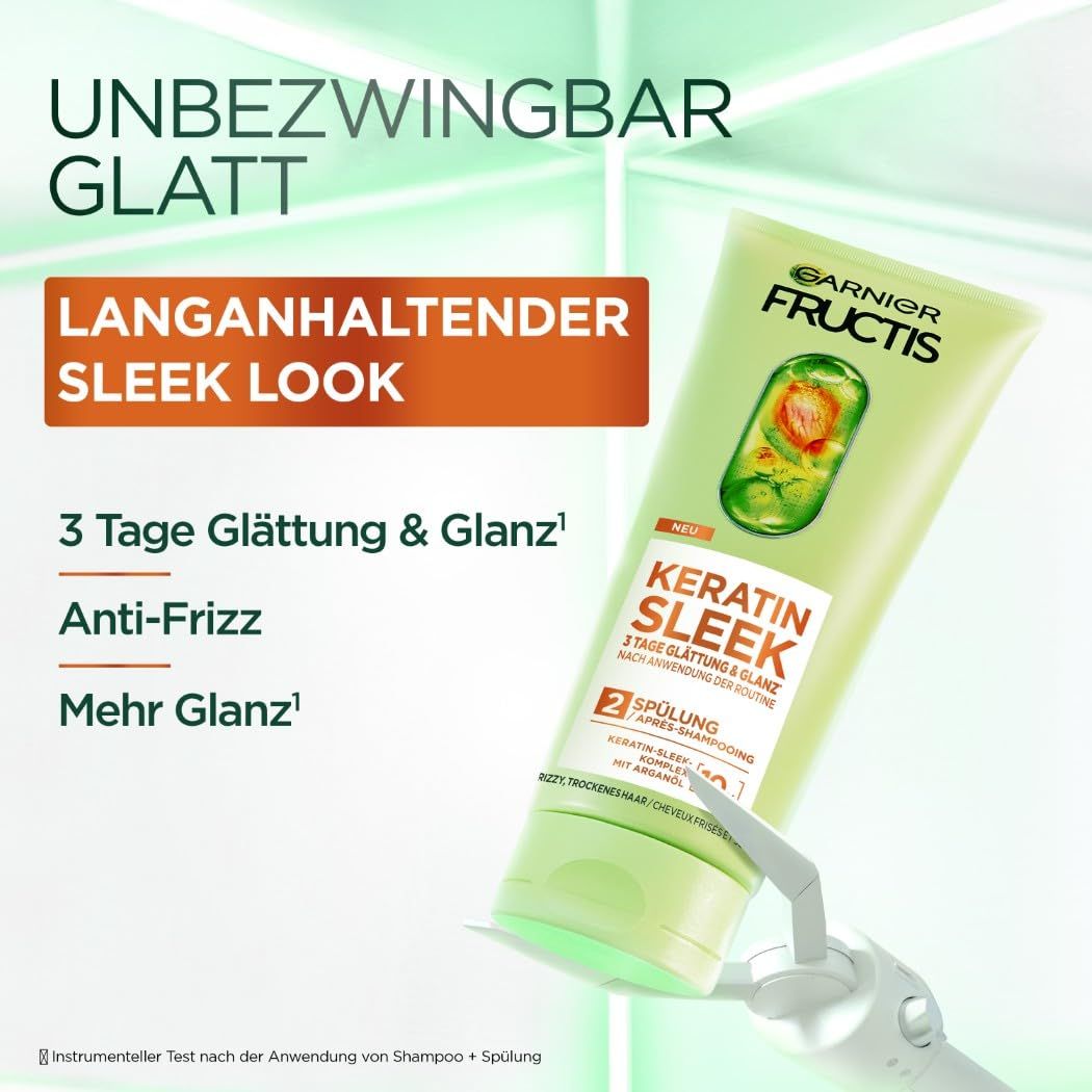 Garnier Fructis Keratin Sleek Spülung. Grüne Tube mit Produktnamen und Angaben zu Glättung und Anti-Frizz.