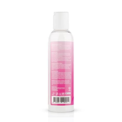 Rückseite einer Flasche weißes Gleitgel. Rosa Etikett mit Text und Barcode. Weißer Deckel.
