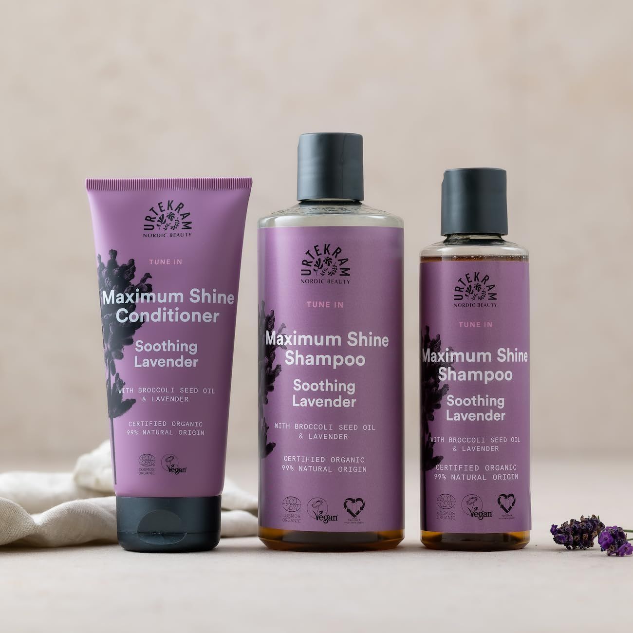 Drei Produkte nebeneinander. Text: Maximum Shine Conditioner, Shampoo. Zertifizierungen: Vegan, Cosmos Organic.