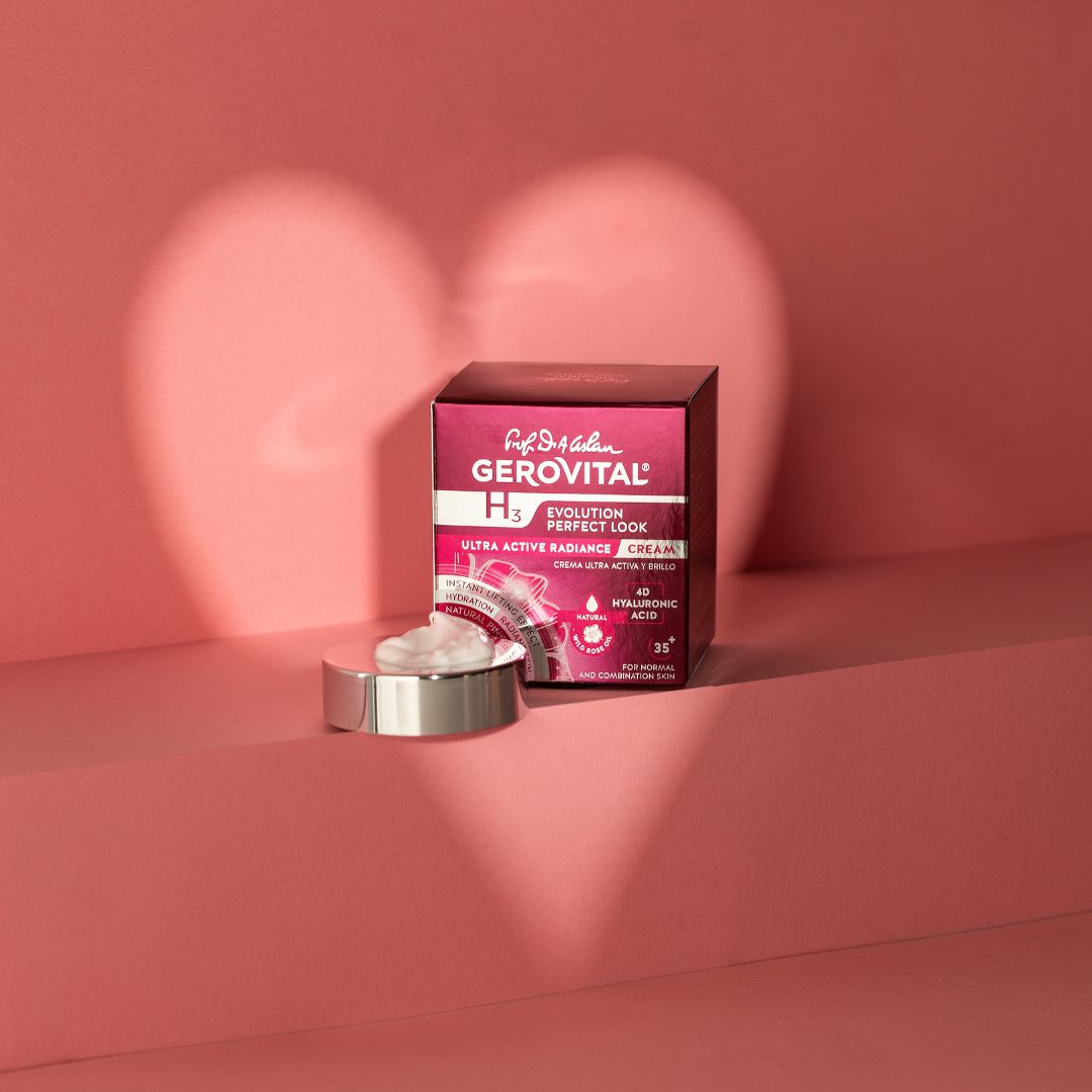 Creme-Tiegel und Schachtel vor rosa Hintergrund. Aufschrift: Gerovital, H3, Evolution Perfect Look. Herzförmiger Schatten.