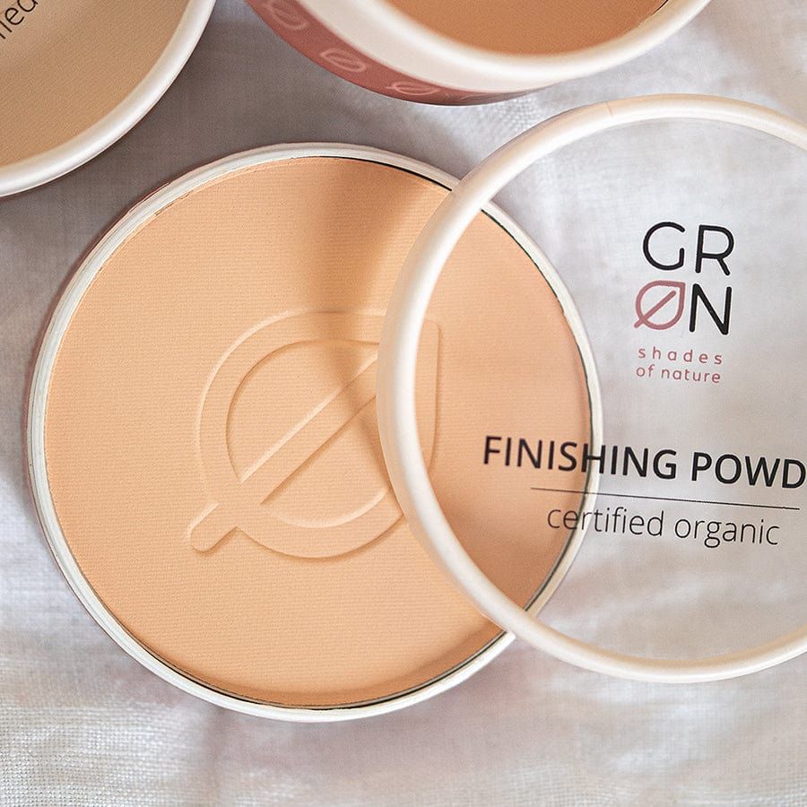 Beige Puder in runder Dose mit transparentem Deckel. GRØN-Logo und Schriftzug „Finishing Powder“. Zertifiziertes Bio-Produkt.