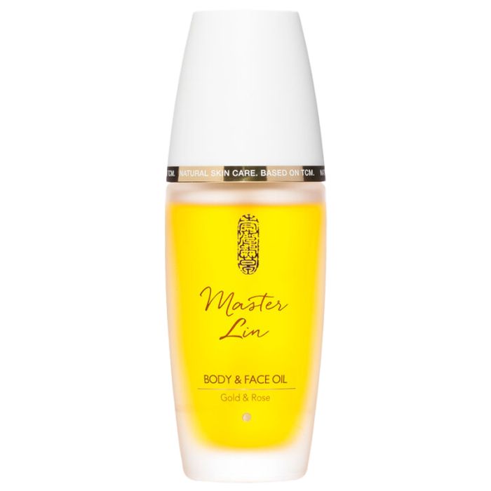 Zylindrische Flasche mit weißem Deckel. Aufschrift: Master Lin, Body & Face Oil, Gold & Rose. Gelbe Flüssigkeit sichtbar.