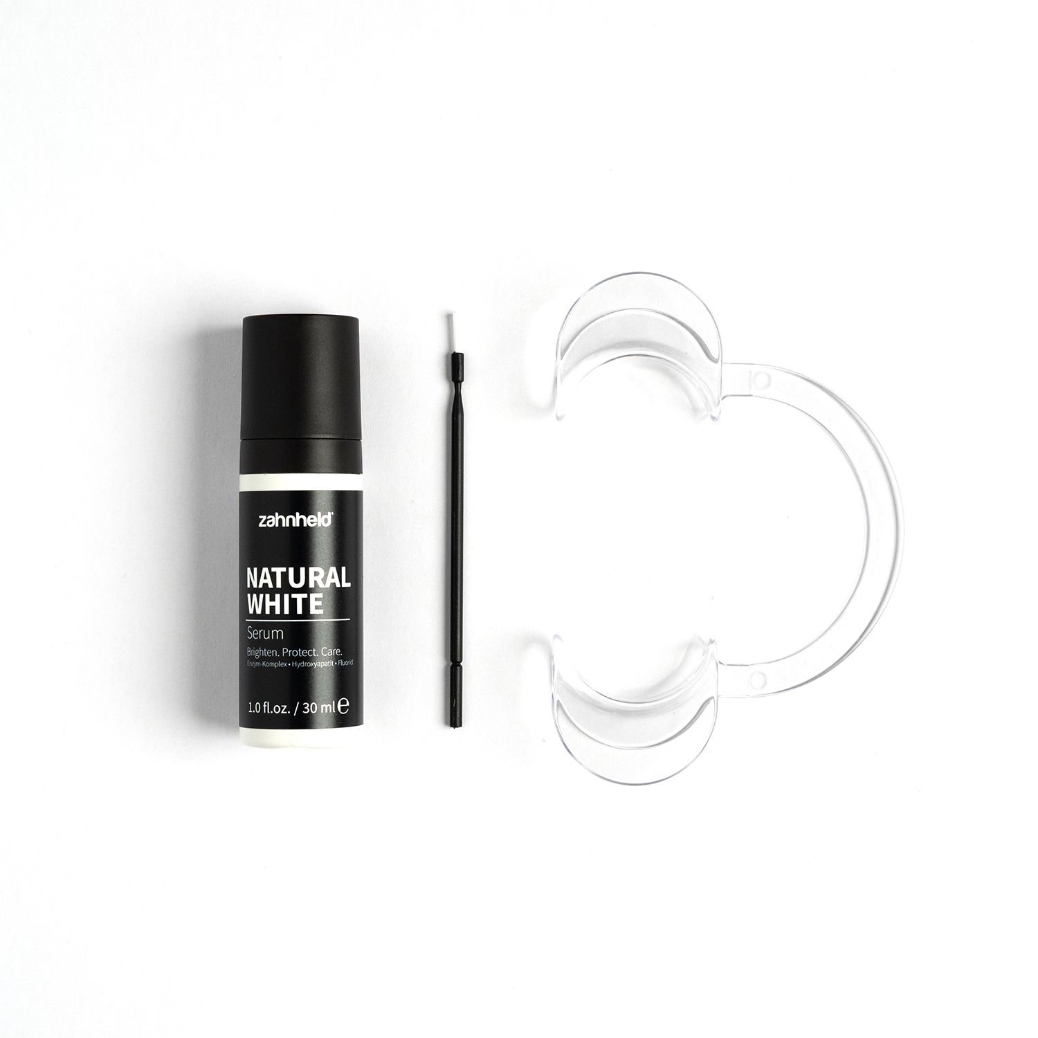 Zahnheld Natural White Serum mit Applikator und Mundspreizer.