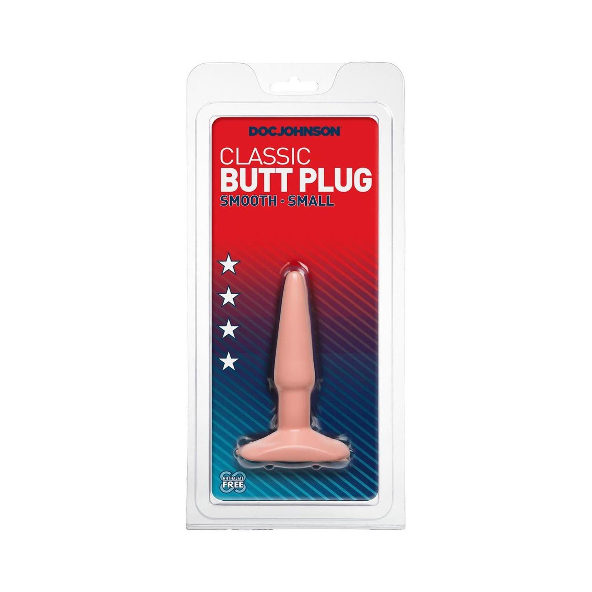 Butt Plug in Verpackung. Rosa, konisch zulaufend, mit breiter Basis. Marke: Doc Johnson. Text: Classic Butt Plug, Smooth Small.