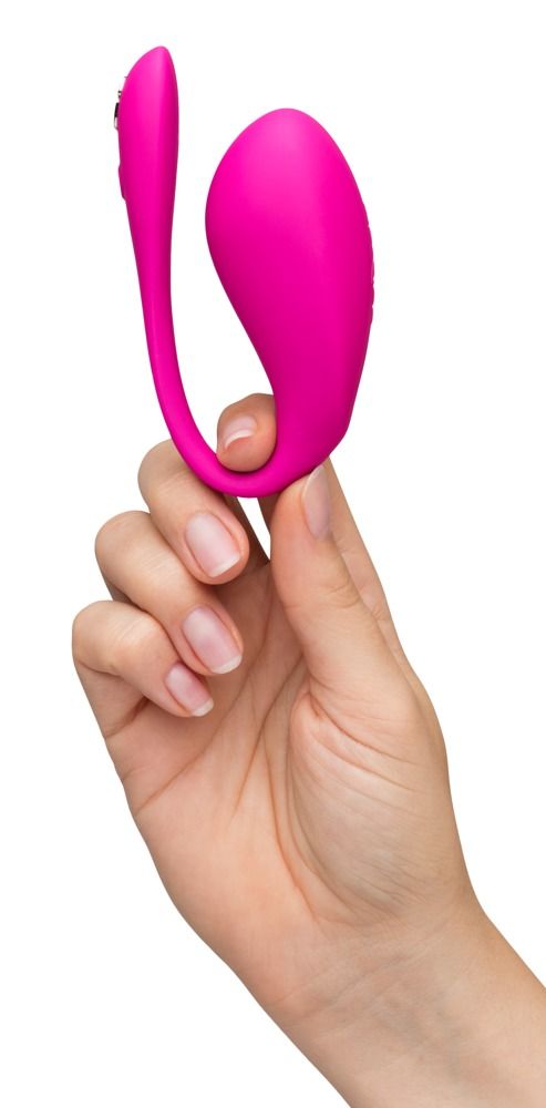 Rosa Vibrator in U-Form, gehalten von einer Hand. Knöpfe auf der Oberfläche.
