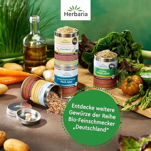 Herbaria Bio-Feinschmecker Deutschland Gewürzmischungen in Dosen, umgeben von frischem Gemüse.